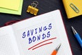 Financial concept about SAVINGS BONDS with inscription on the piece of paper. A U.S.ÃÂ savings bondÃÂ is a governmentÃÂ bondÃÂ offered Royalty Free Stock Photo